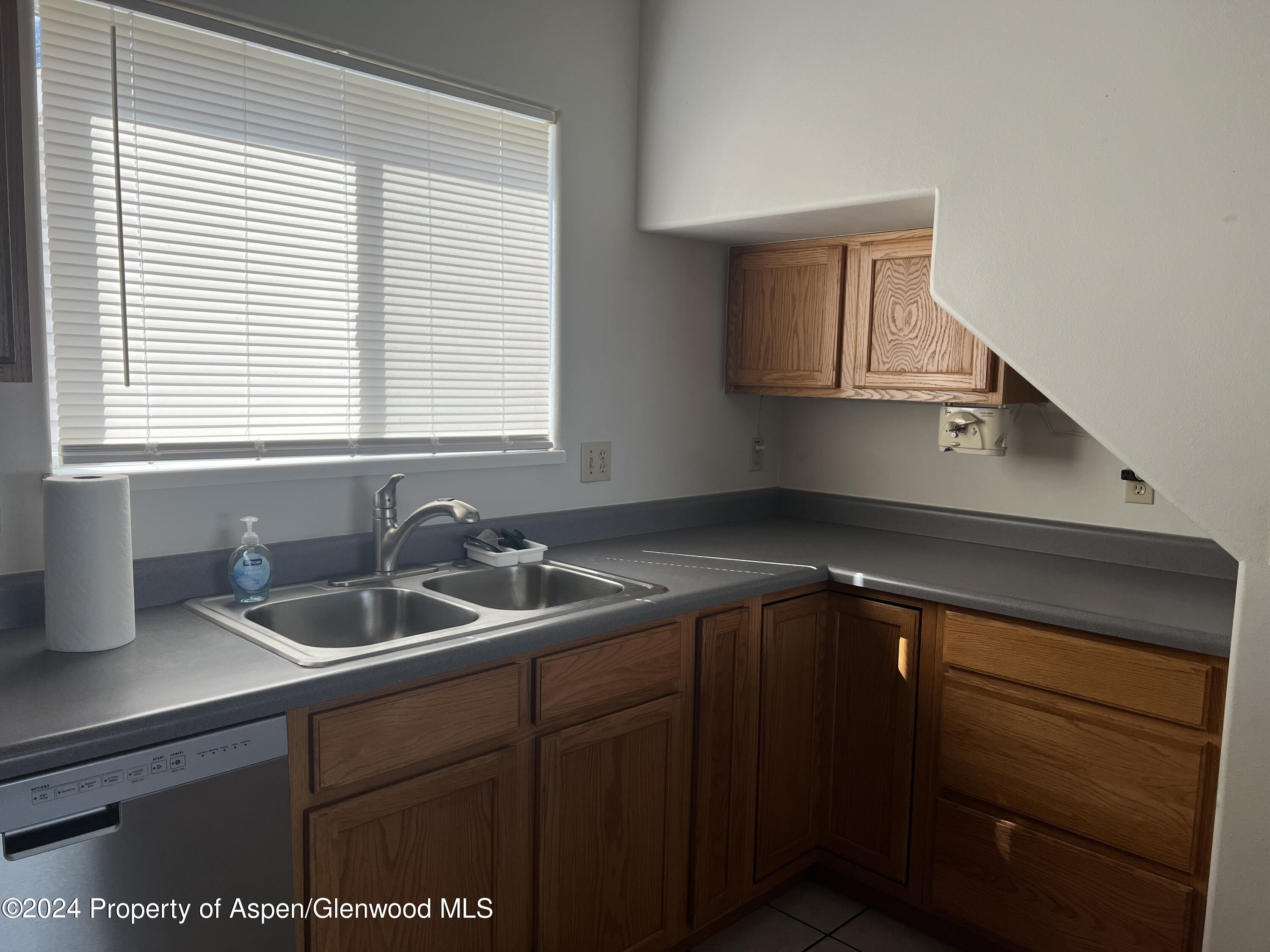424 Lind Avenue Rifle, CO 81650 - Photo 8 of 24 a kitchen with a sink and cabinets