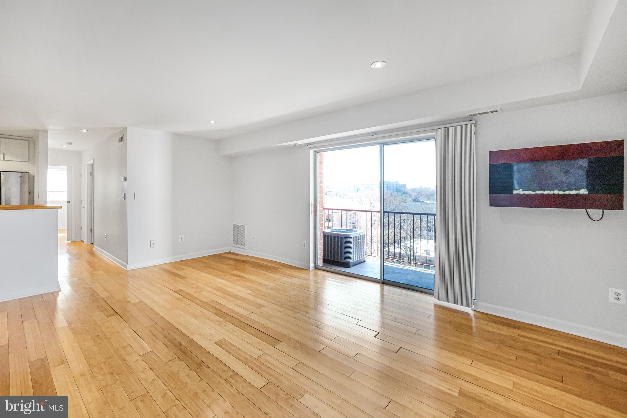 2634 Bowen Road Southeast, Unit 404 Washington, DC 20020 - Photo 2 of 15 a view of empty room with wooden floor and fan