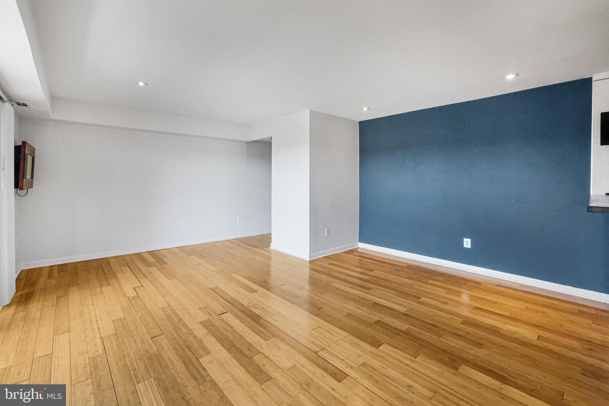 2634 Bowen Road Southeast, Unit 404 Washington, DC 20020 - Photo 3 of 15 a view of an empty room with wooden floor