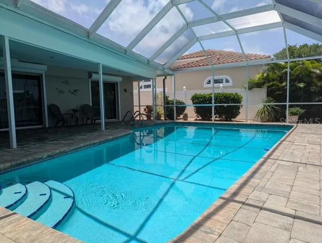 a view of swimming pool with outdoor seating