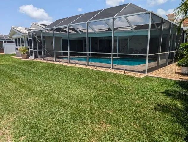 a view of a house with a yard and a large window