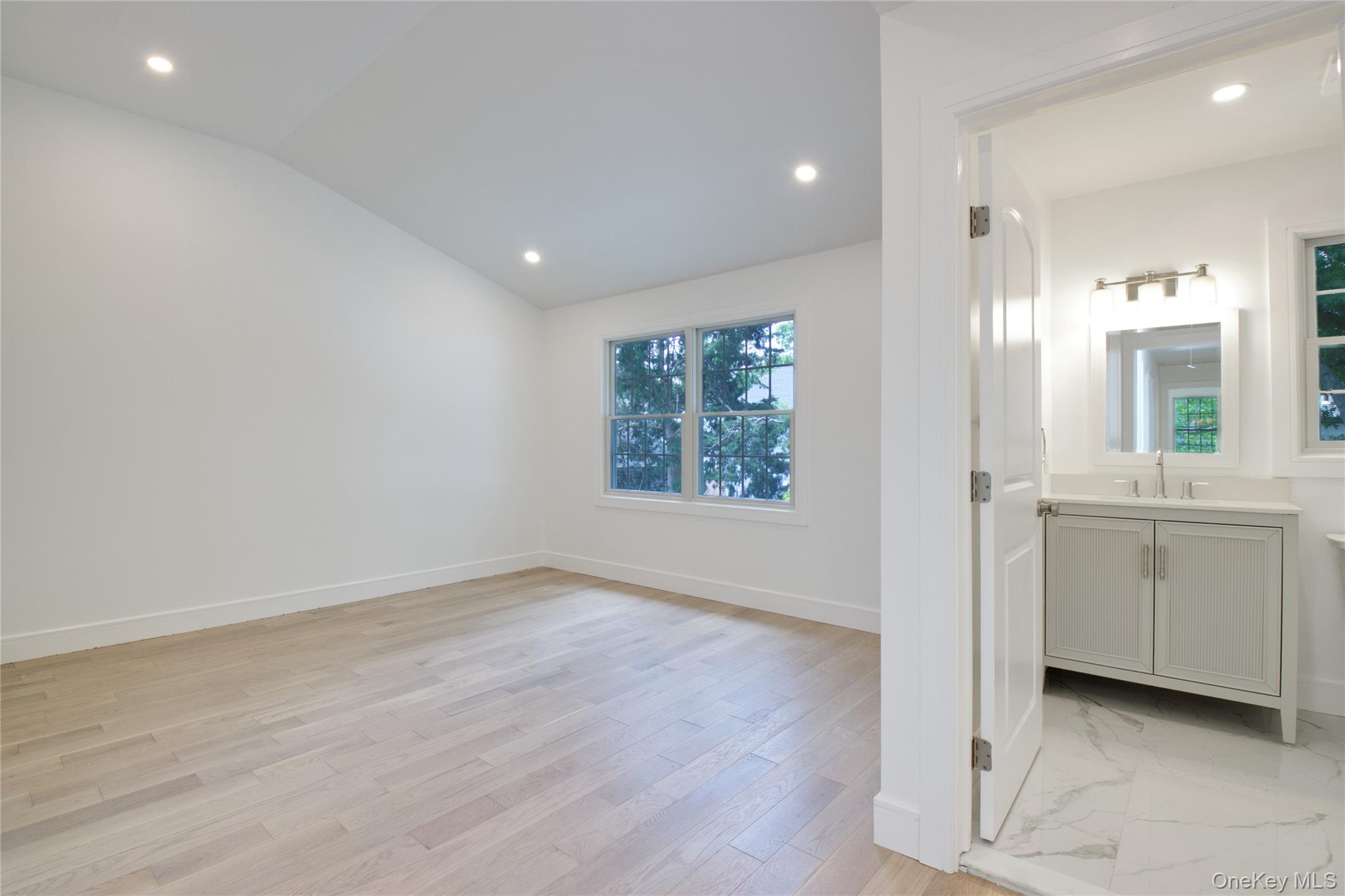30 Kirkwood Road, Unit B Port Washington, NY 11050 - Photo 17 of 36 wooden floor in an empty room with a window