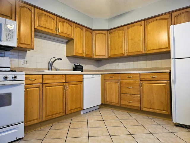 a kitchen with cabinets a sink and appliances