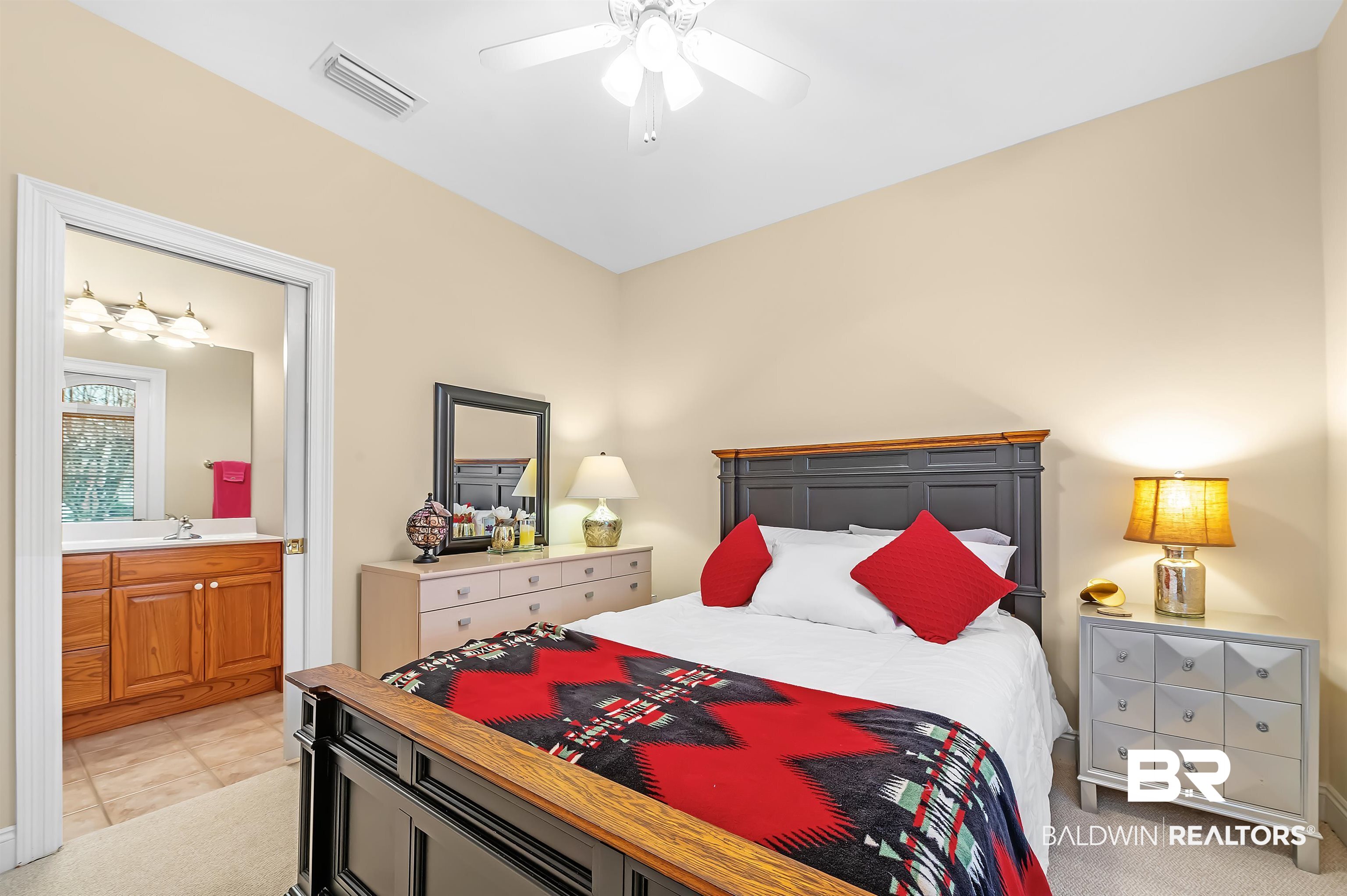 22726 Inverness Way Foley, AL 36535 - Photo 41 of 51 Bedroom featuring ensuite bath, ceiling fan, sink, and light colored carpet