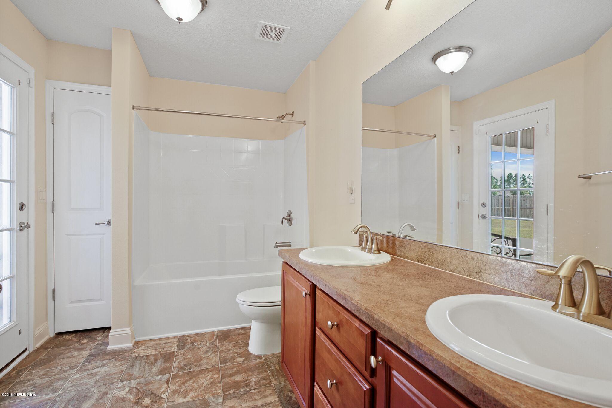 3007 Longleaf Ranch Circle Middleburg, FL 32068 - Photo 10 of 27 2nd Bathroom with door to patio