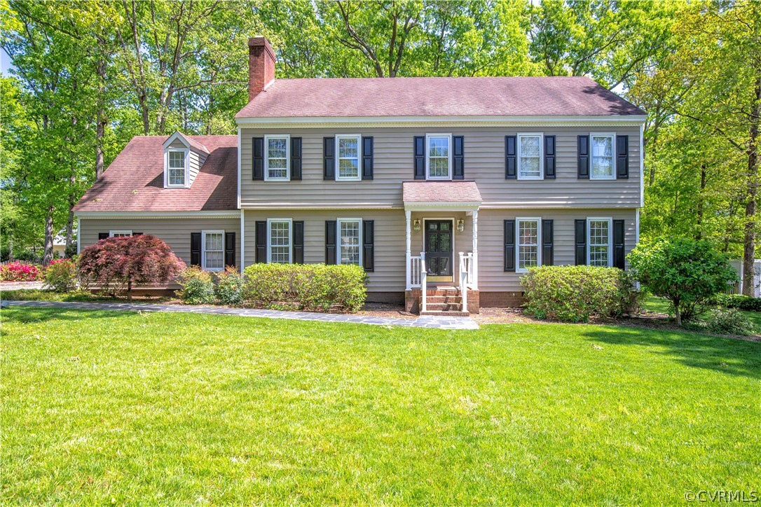 2111 Corner Rock Road Midlothian, VA 23113 - Photo 32 of 35 a front view of a house with a garden and porch