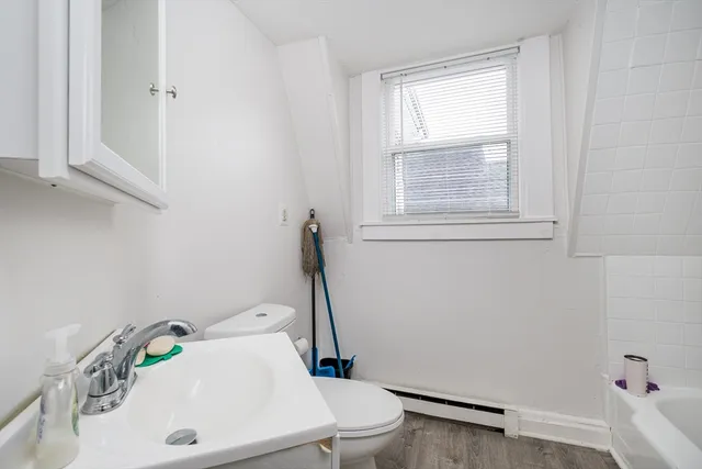 a bathroom with a sink a toilet and tub