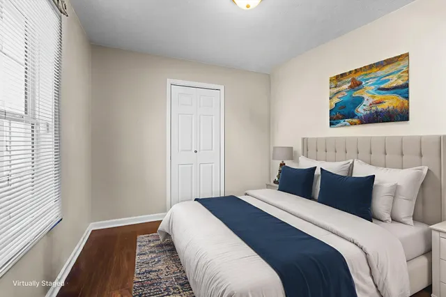 a bedroom with bed and wall painting with wooden floor