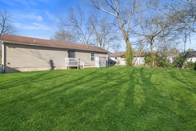a house view with a sitting space and garden
