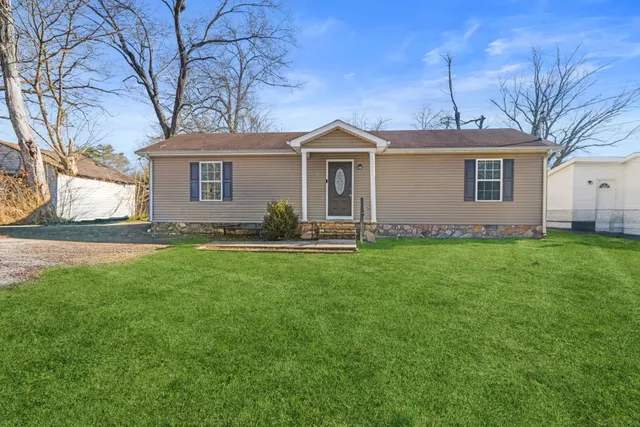 a front view of house with yard and green space