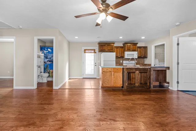 a kitchen with stainless steel appliances kitchen island granite countertop a stove and a refrigerator