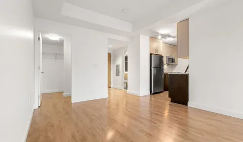 a view of a hallway with wooden floor