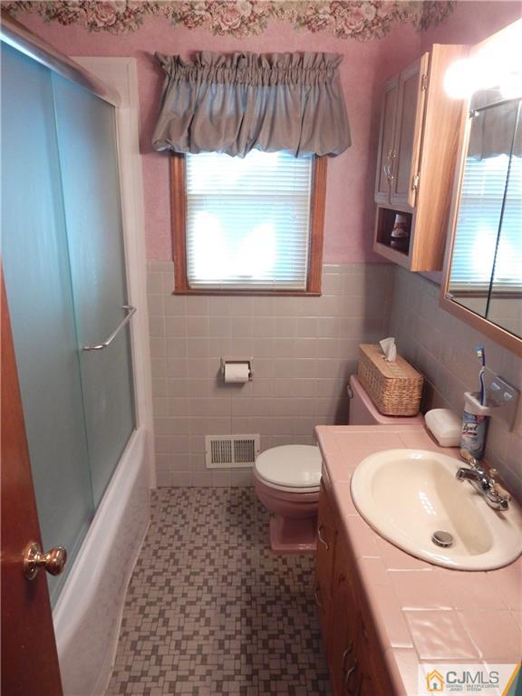 107 West Hill Road Colonia, NJ 07067 - Photo 13 of 16 a bathroom with a toilet sink and mirror
