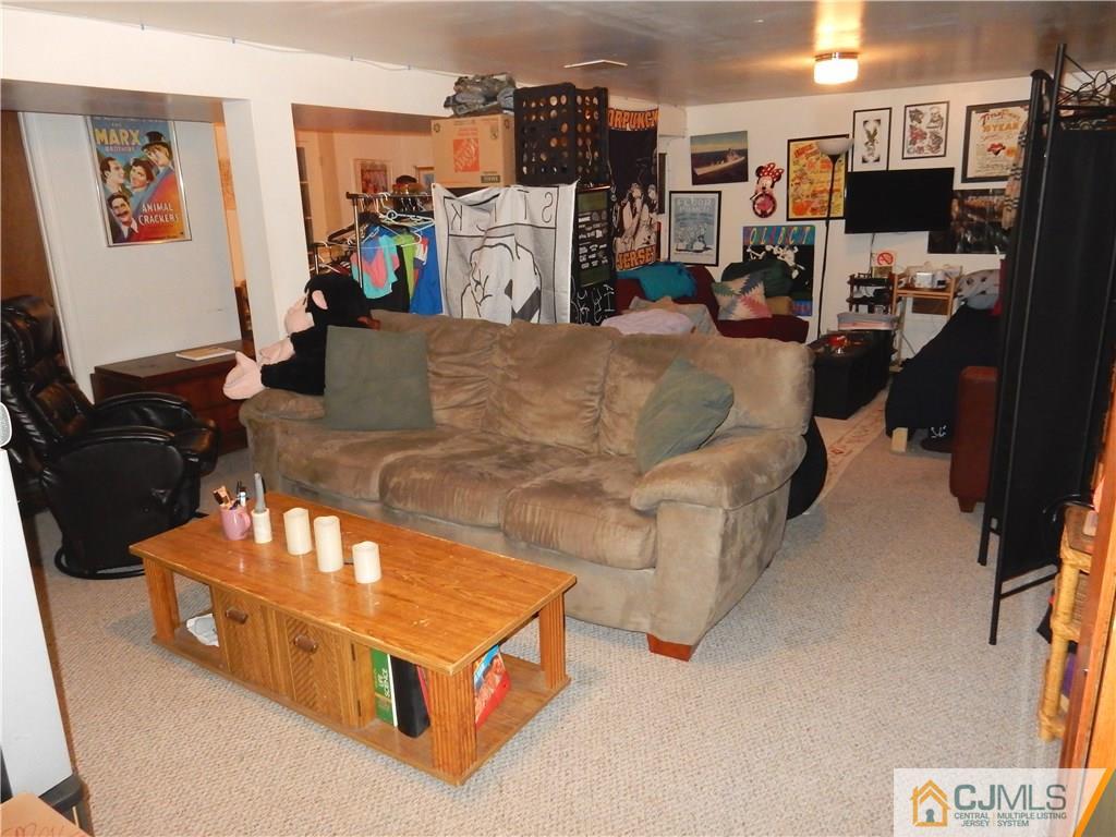 107 West Hill Road Colonia, NJ 07067 - Photo 14 of 16 a living room with furniture and a flat screen tv