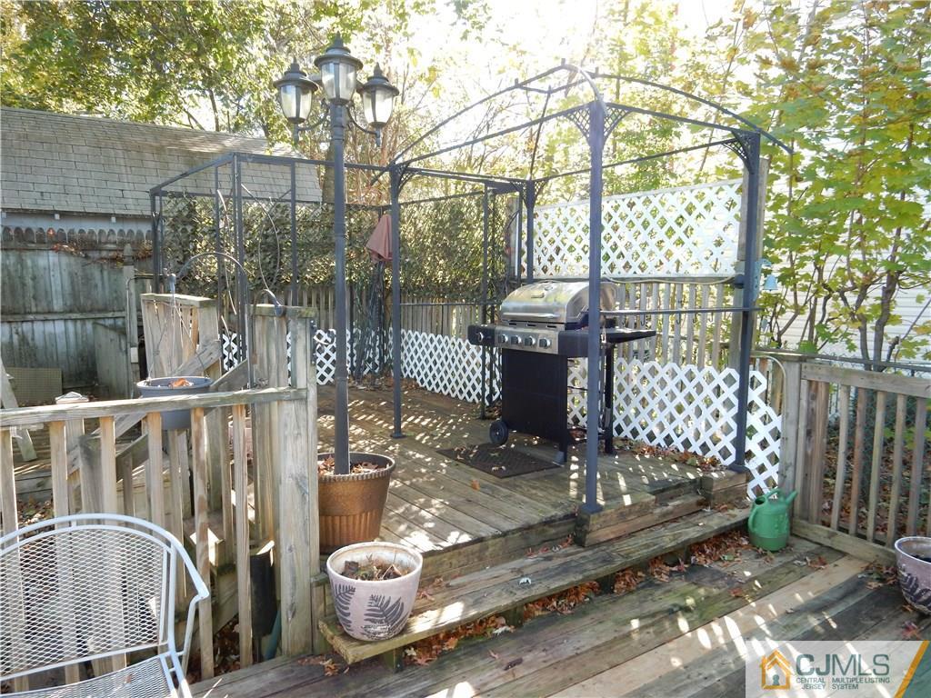 107 West Hill Road Colonia, NJ 07067 - Photo 15 of 16 a view of a chairs and table in backyard