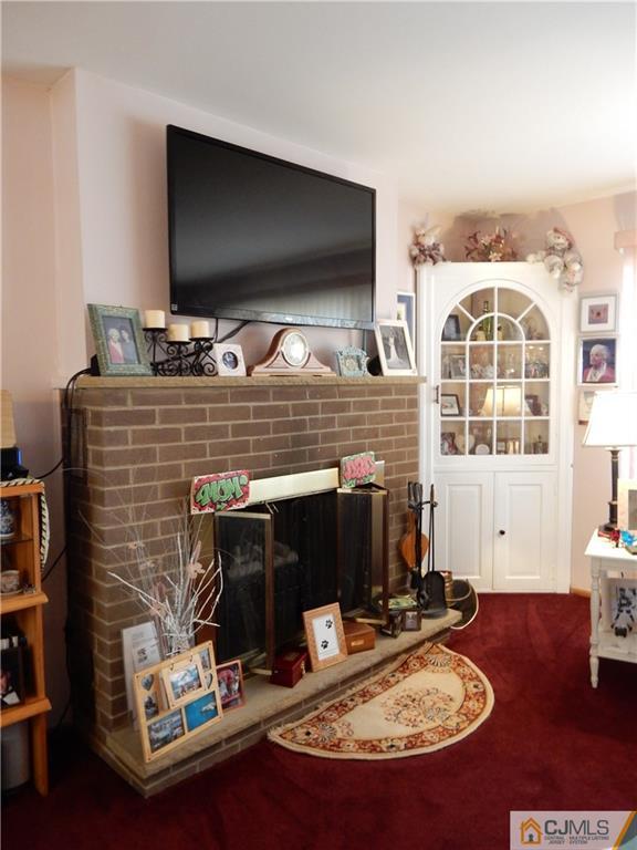 107 West Hill Road Colonia, NJ 07067 - Photo 4 of 16 a living room with fireplace furniture and a flat screen tv
