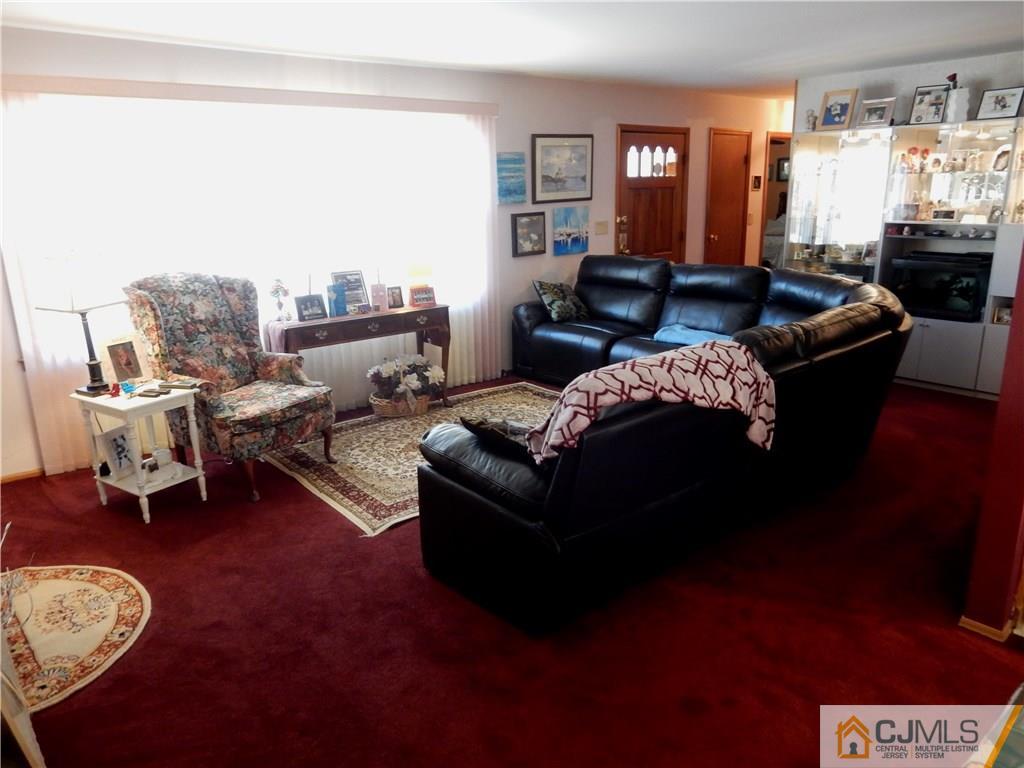 107 West Hill Road Colonia, NJ 07067 - Photo 5 of 16 a living room with furniture and a large window