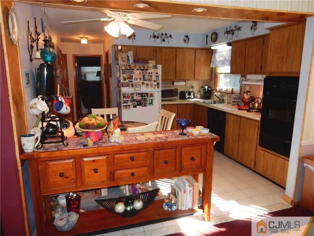 107 West Hill Road Colonia, NJ 07067 - Photo 6 of 16 a kitchen with stainless steel appliances granite countertop a stove a sink and a refrigerator