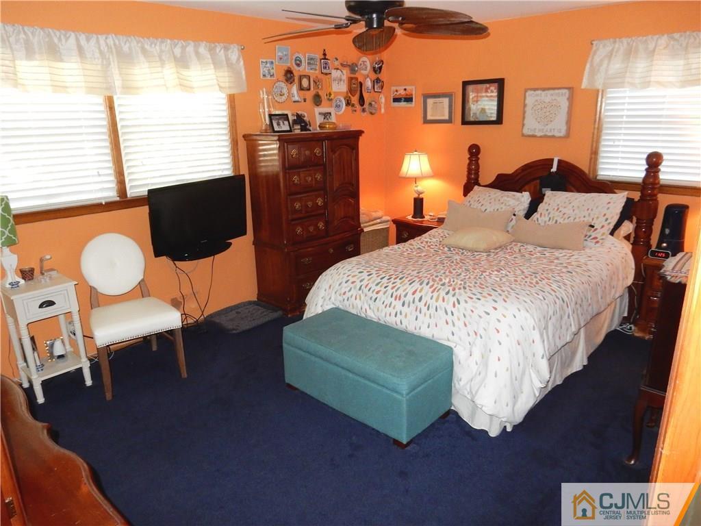 107 West Hill Road Colonia, NJ 07067 - Photo 9 of 16 a bedroom with a bed a lamp and a potted plant