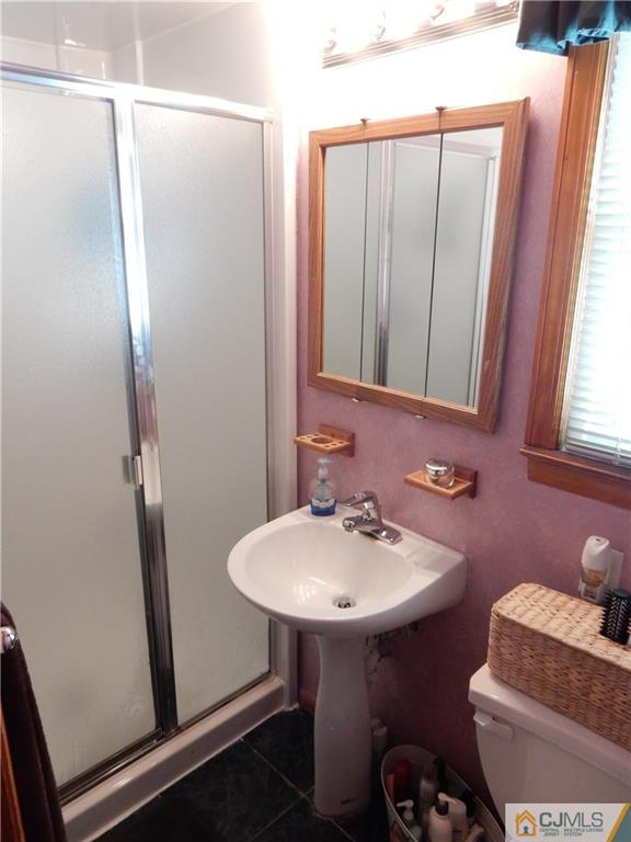 107 West Hill Road Colonia, NJ 07067 - Photo 10 of 16 a bathroom with a sink and a mirror