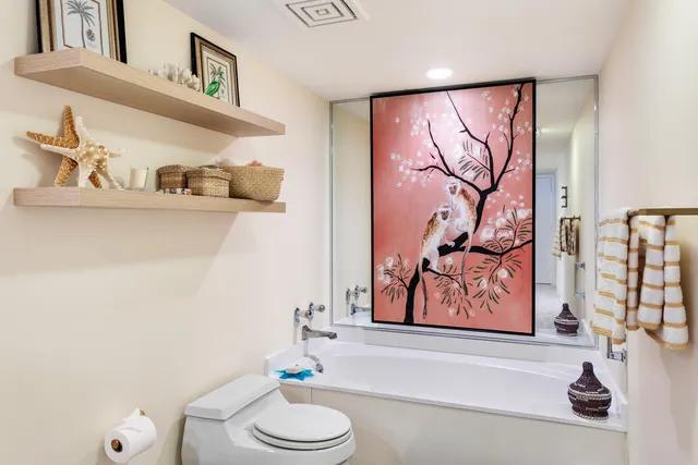 a bathroom with a toilet a sink and a shower curtain