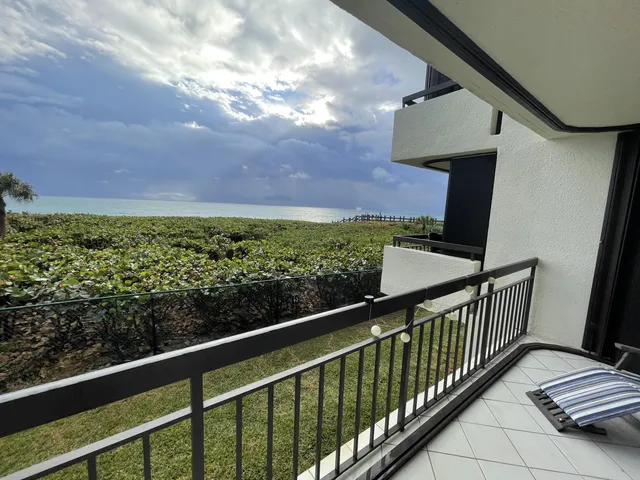 a view of balcony with wooden floor and fence