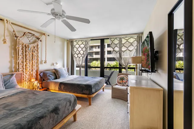 a bedroom with furniture and large windows