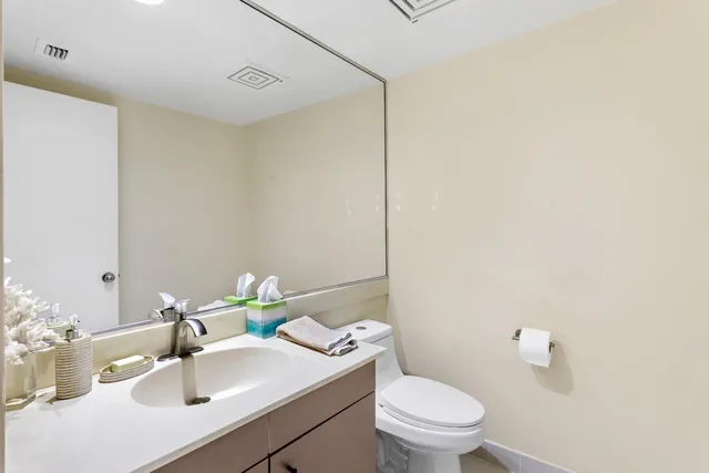 a bathroom with a sink toilet and a mirror