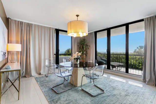 a view of a livingroom with furniture and floor to ceiling window