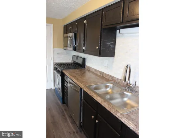 a kitchen with stainless steel appliances granite countertop a sink and cabinets