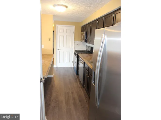 a kitchen with a refrigerator and a sink