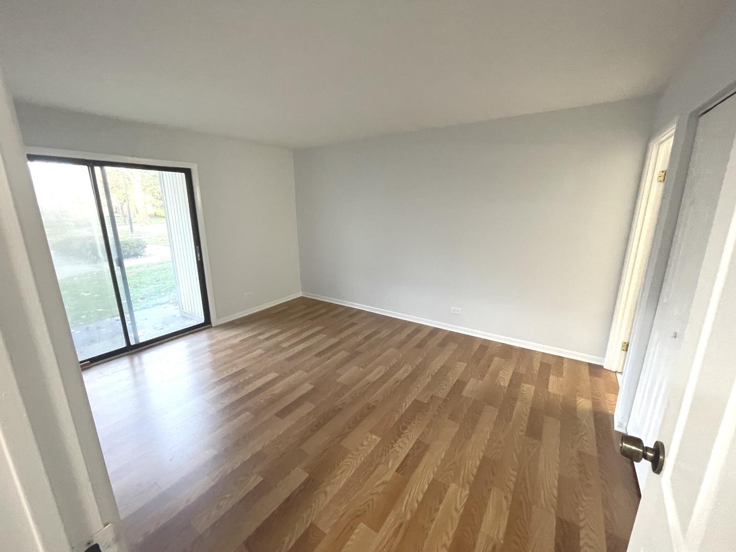 500 74th Street, Unit 102 Downers Grove, IL 60516 - Photo 11 of 21 an empty room with wooden floor and windows