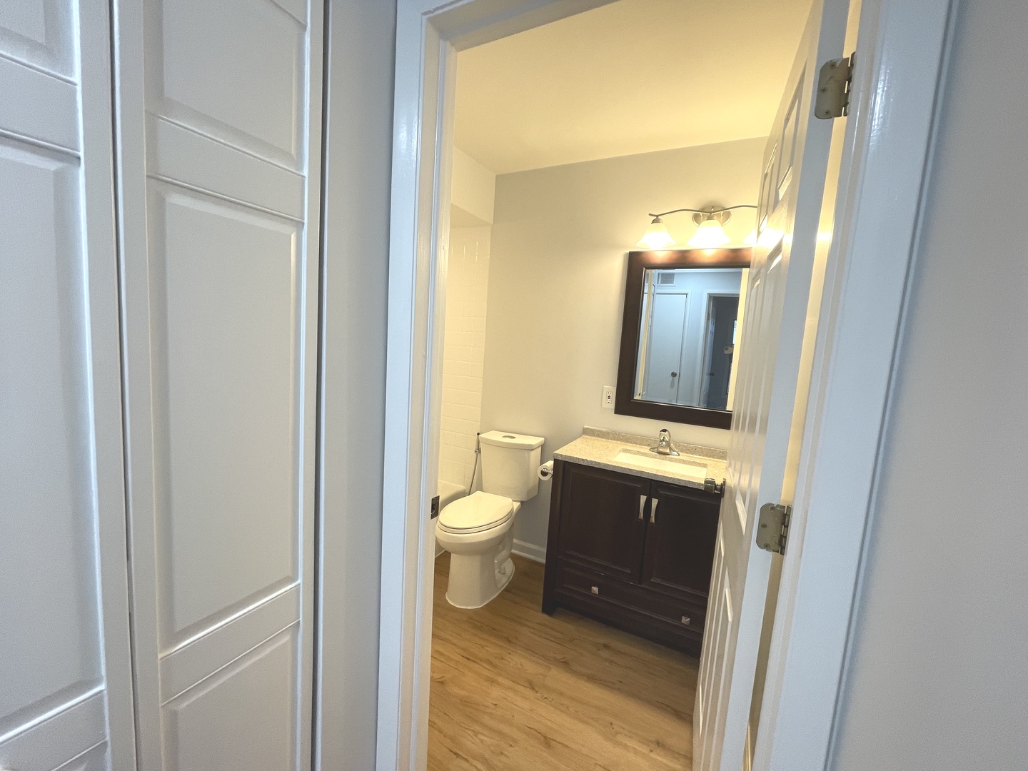 500 74th Street, Unit 102 Downers Grove, IL 60516 - Photo 12 of 21 a bathroom with a sink and mirror with toilet
