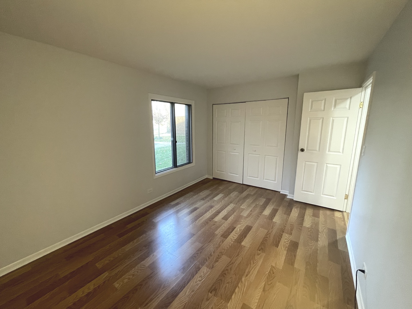 500 74th Street, Unit 102 Downers Grove, IL 60516 - Photo 14 of 21 a view of empty room with wooden floor and fan