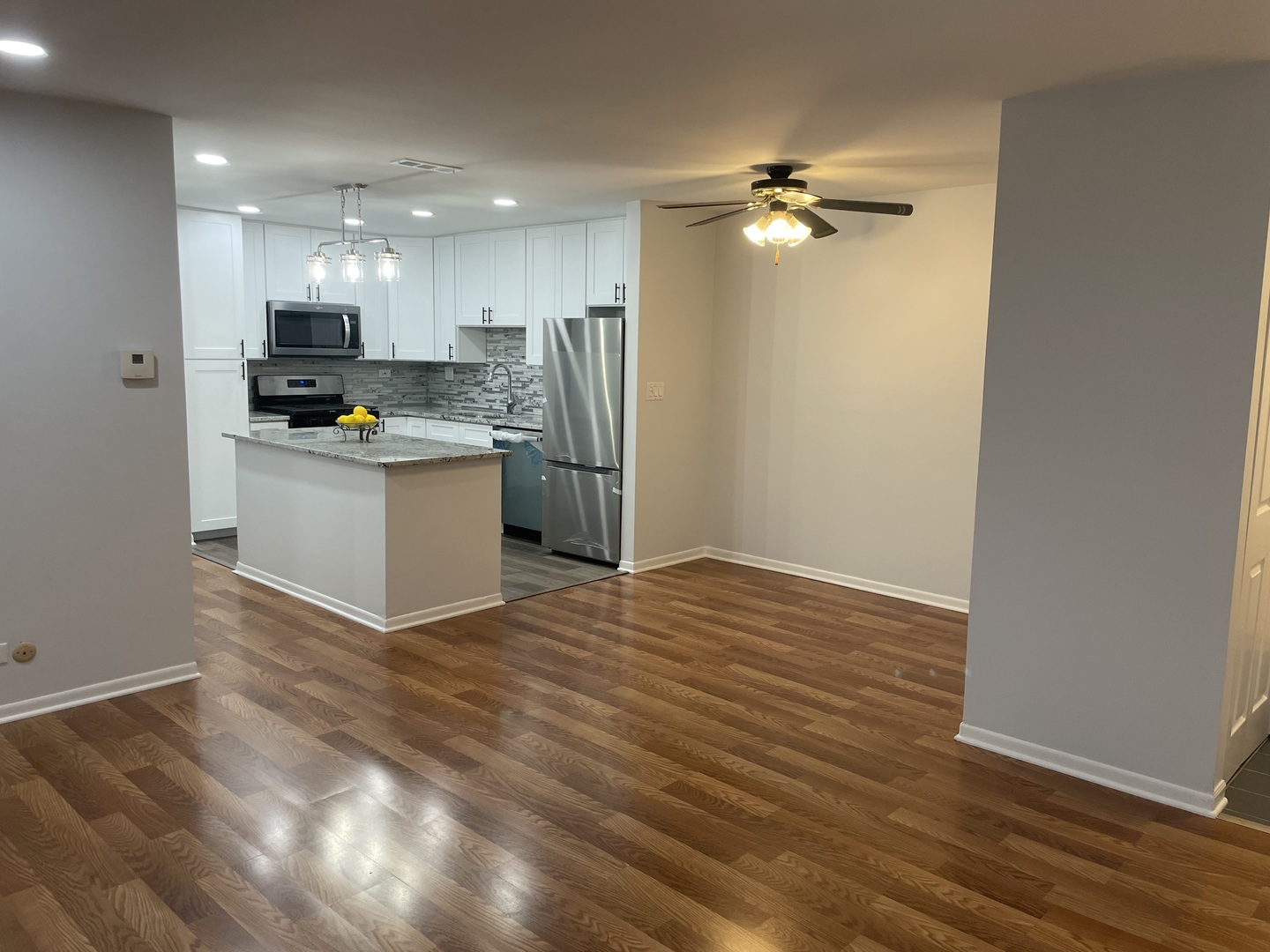 500 74th Street, Unit 102 Downers Grove, IL 60516 - Photo 3 of 21 a view of a kitchen with a sink and a refrigerator