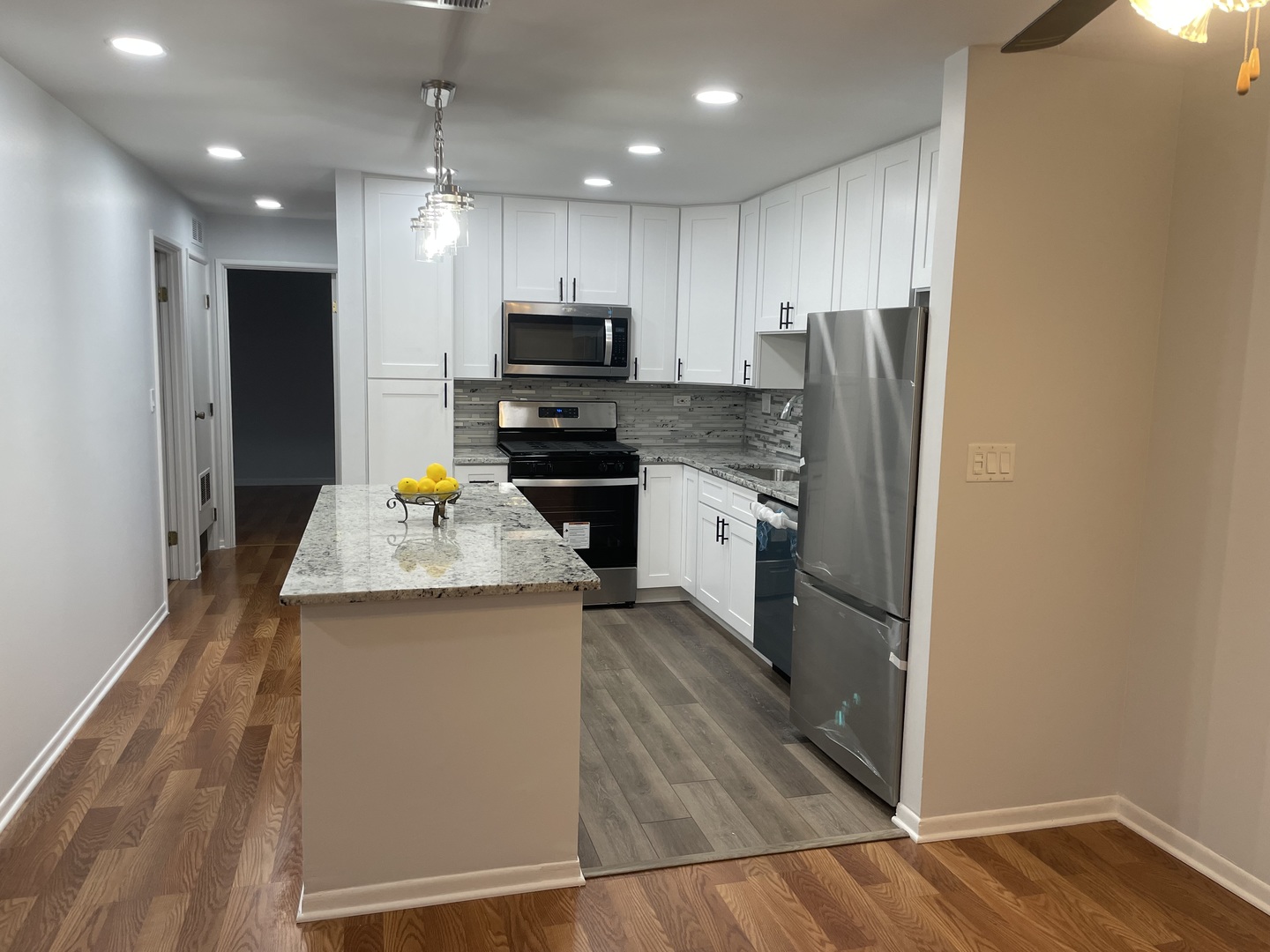 500 74th Street, Unit 102 Downers Grove, IL 60516 - Photo 4 of 21 a kitchen with stainless steel appliances granite countertop a refrigerator a stove top oven a sink and dishwasher