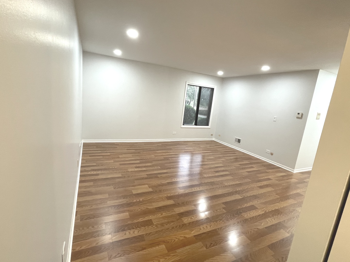 500 74th Street, Unit 102 Downers Grove, IL 60516 - Photo 7 of 21 a view of empty room with wooden floor and fan