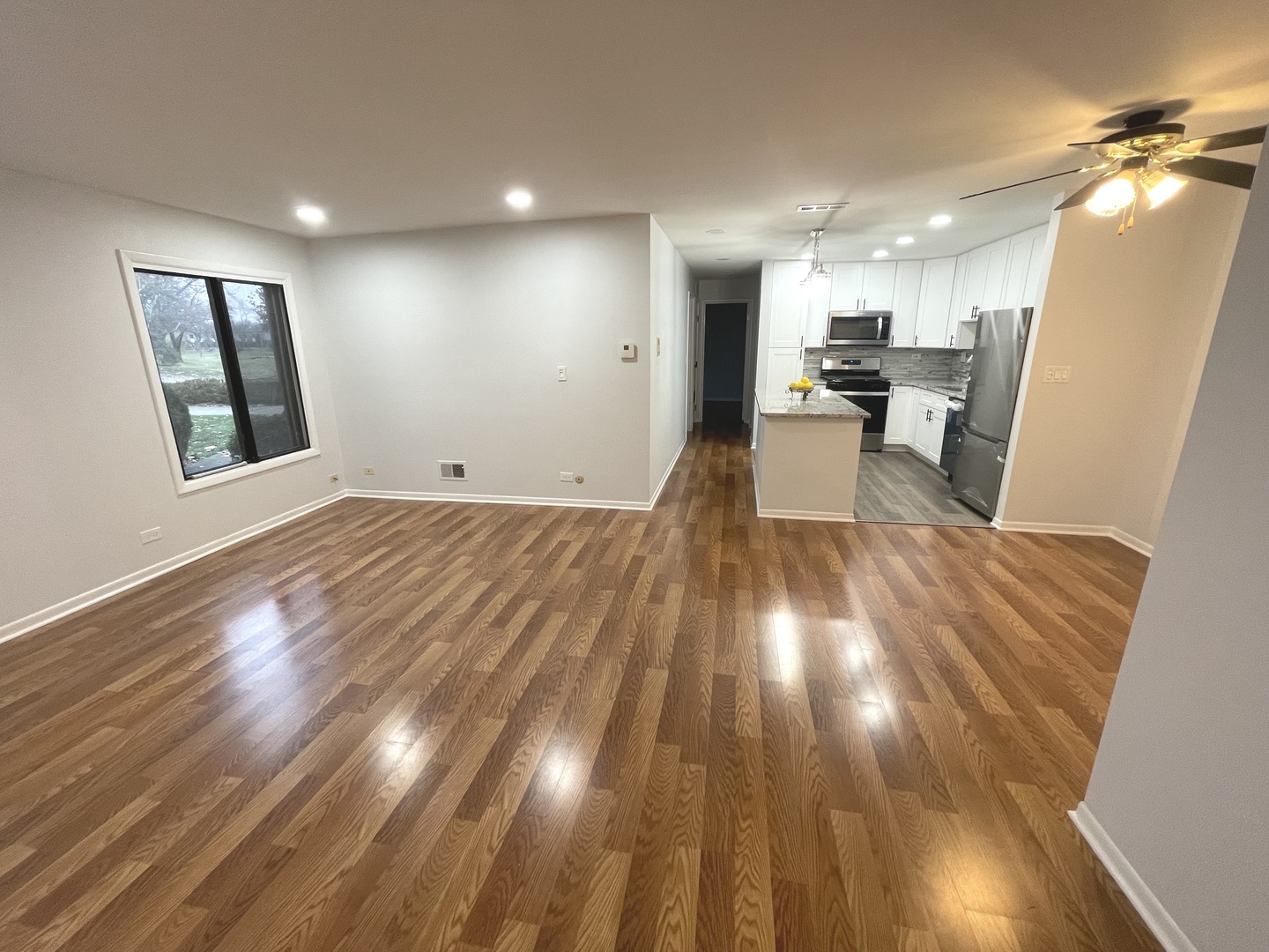 500 74th Street, Unit 102 Downers Grove, IL 60516 - Photo 8 of 21 a view of a big room with wooden floor and windows