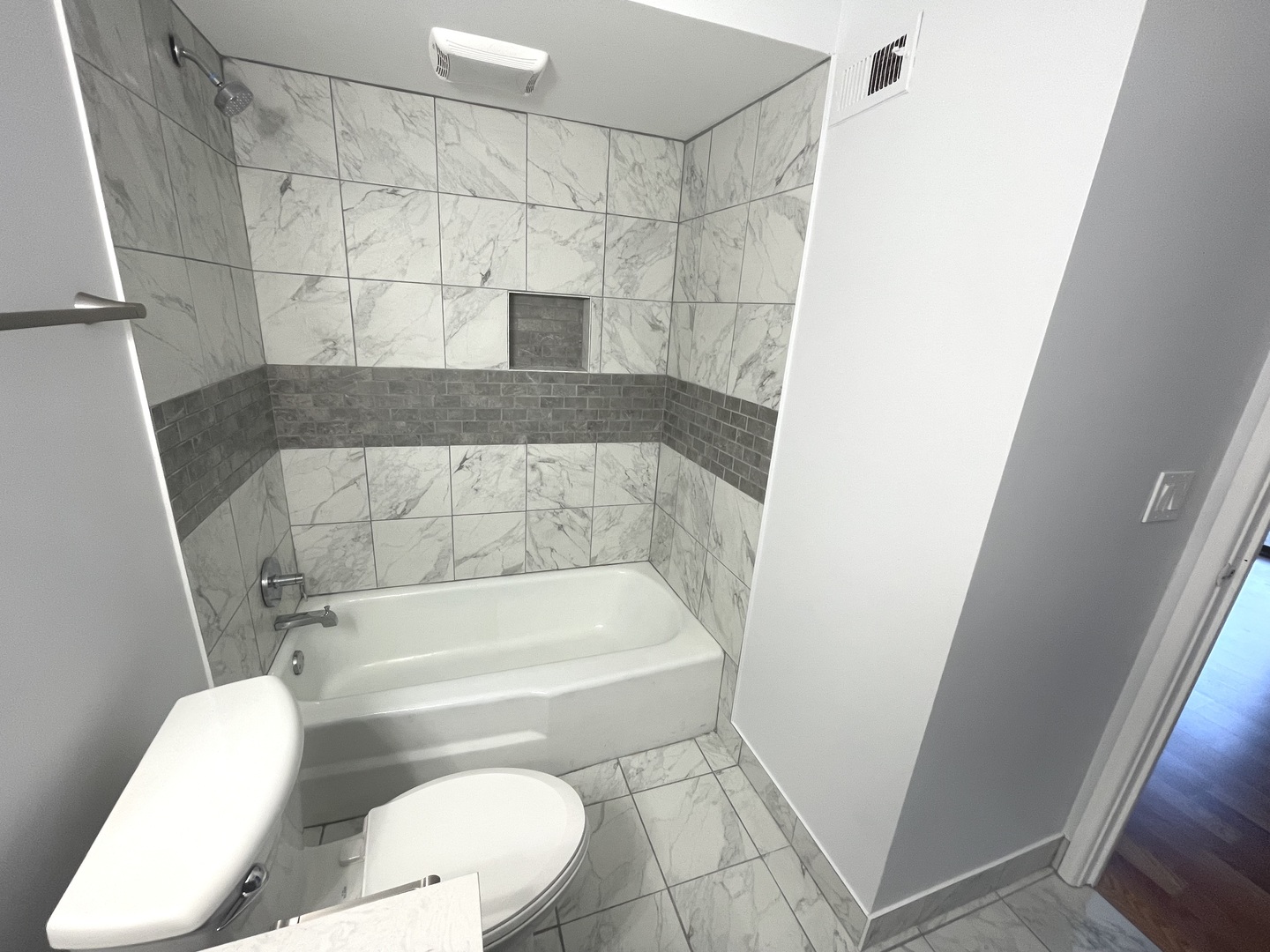 500 74th Street, Unit 102 Downers Grove, IL 60516 - Photo 10 of 21 a white toilet sitting next to a bath tub