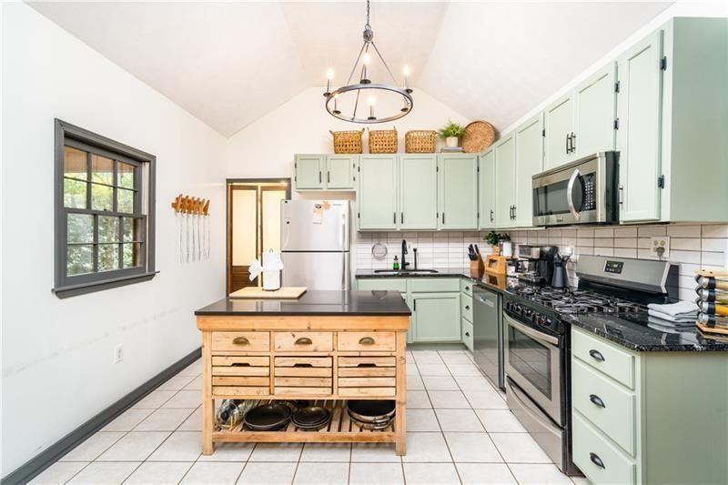 2889 Old Parker Pl Road Ellijay, GA 30536 - Photo 12 of 59 a kitchen with stainless steel appliances a stove a sink cabinets and a dining table