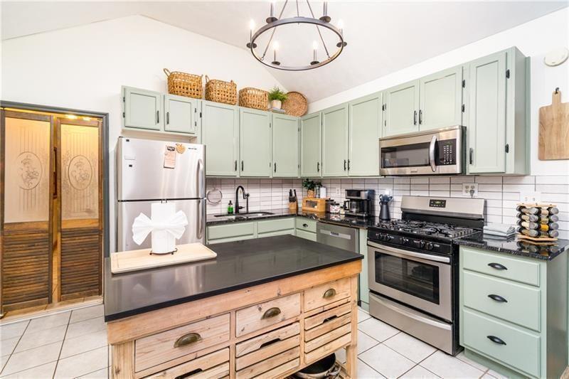 2889 Old Parker Pl Road Ellijay, GA 30536 - Photo 13 of 59 a kitchen with stainless steel appliances granite countertop a stove a sink and a refrigerator
