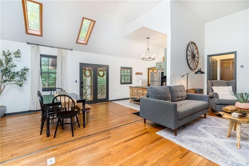 2889 Old Parker Pl Road Ellijay, GA 30536 - Photo 14 of 59 a living room with furniture a dining table and a clock
