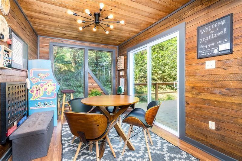 2889 Old Parker Pl Road Ellijay, GA 30536 - Photo 19 of 59 a view of a dining room with furniture large windows and wooden floor