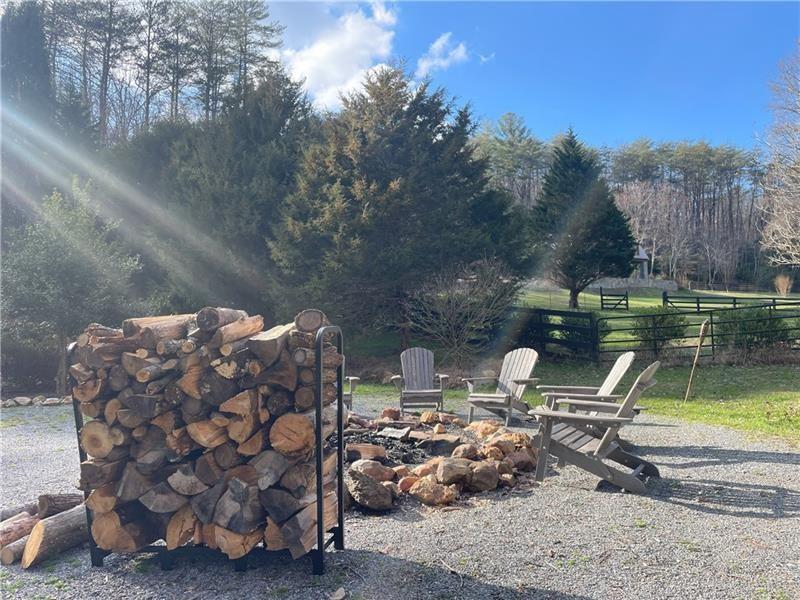 2889 Old Parker Pl Road Ellijay, GA 30536 - Photo 9 of 59 a view of a chairs and table in backyard