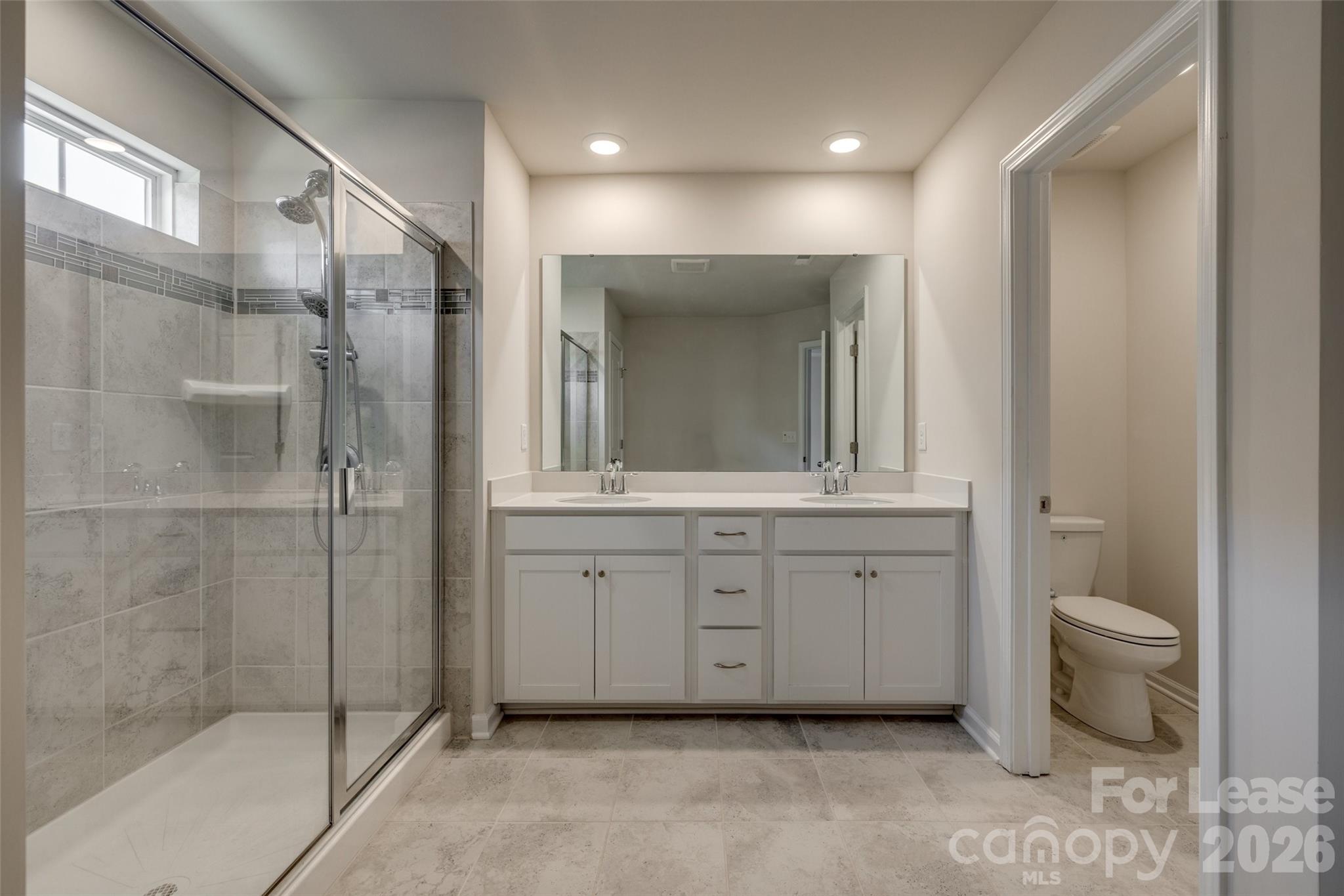807 Gable Oak Lane Fort Mill, SC 29708 - Photo 21 of 39 a spacious bathroom with a shower sink and mirror