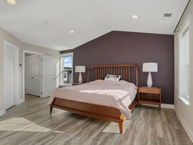 a spacious bedroom with a bed and a table