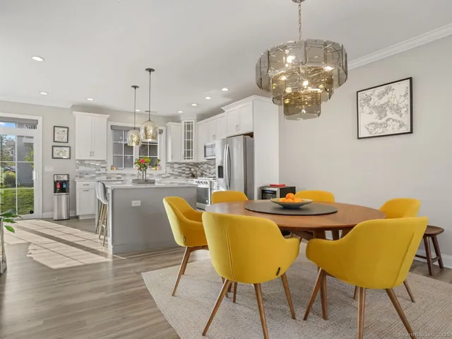 a view of a dining room with furniture and chandelier