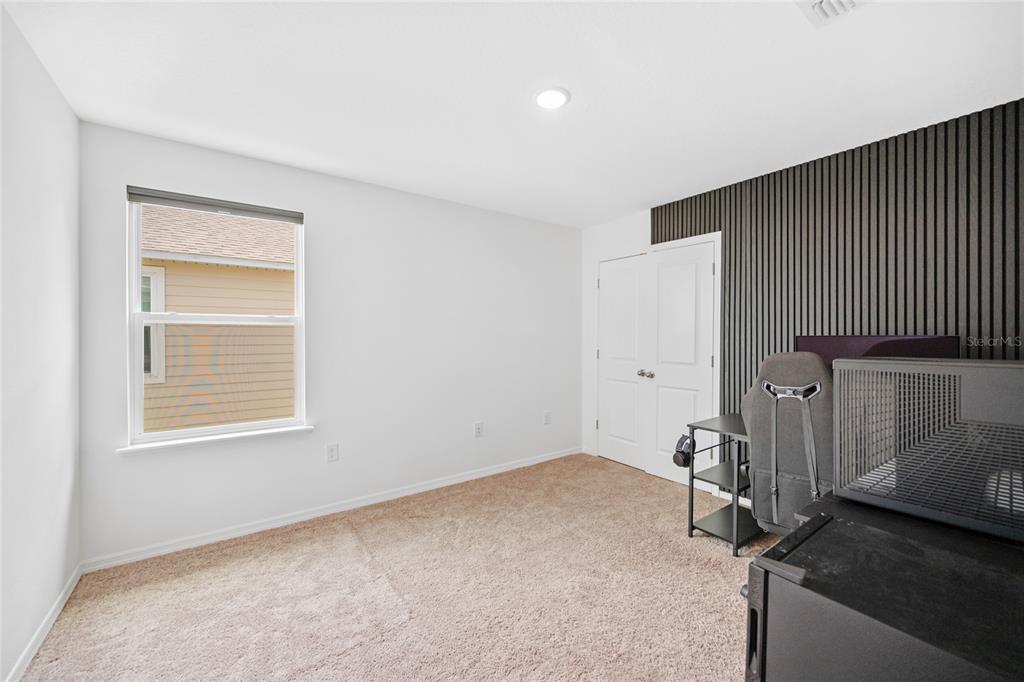 1137 Bradford Rdg Drive Leesburg, FL 34748 - Photo 26 of 37 a room with a bed and a window