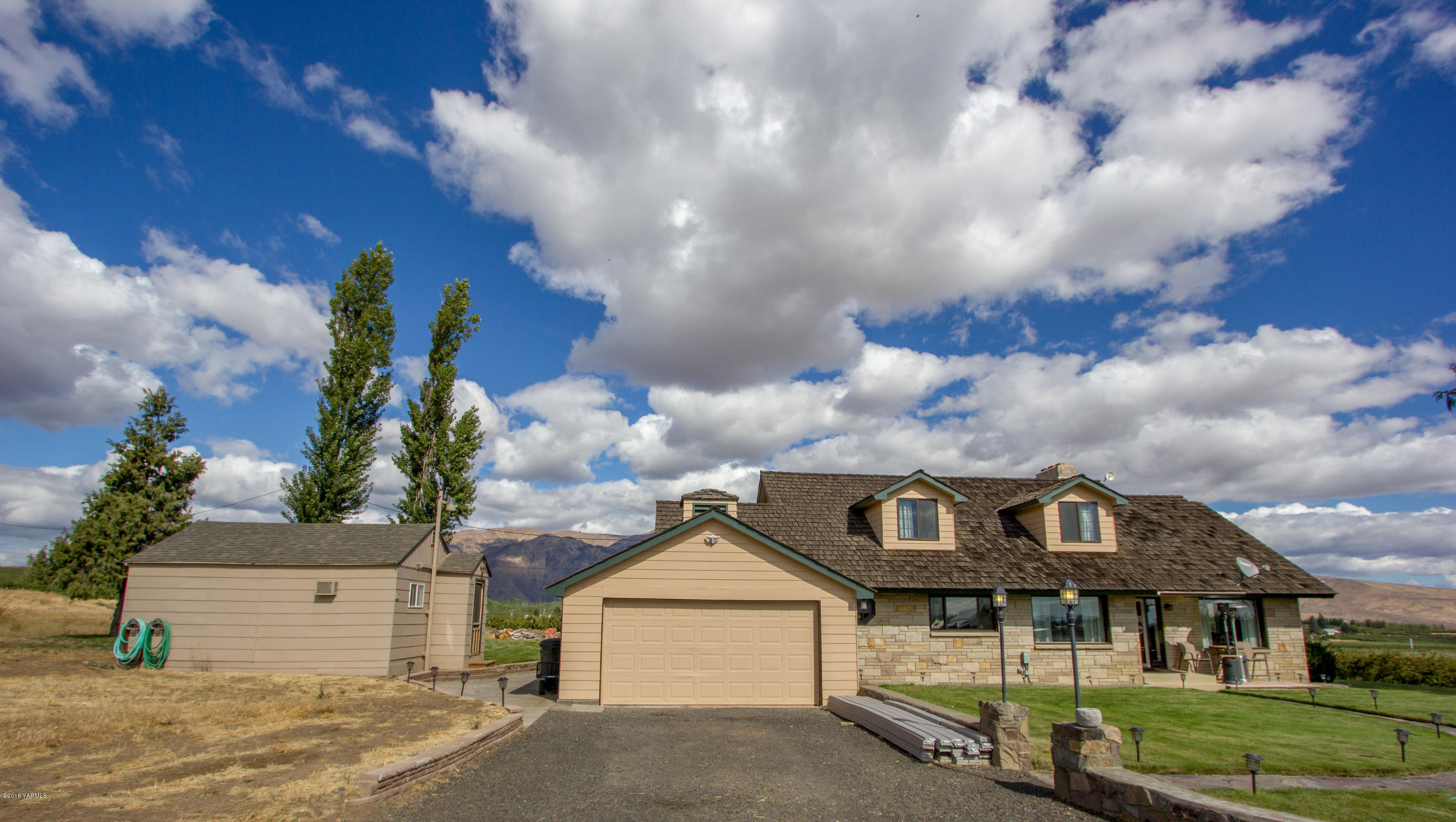 491 Section 1 Road Tieton, WA 98947 - Photo 1 of 23 a front view of a house with a yard and garage
