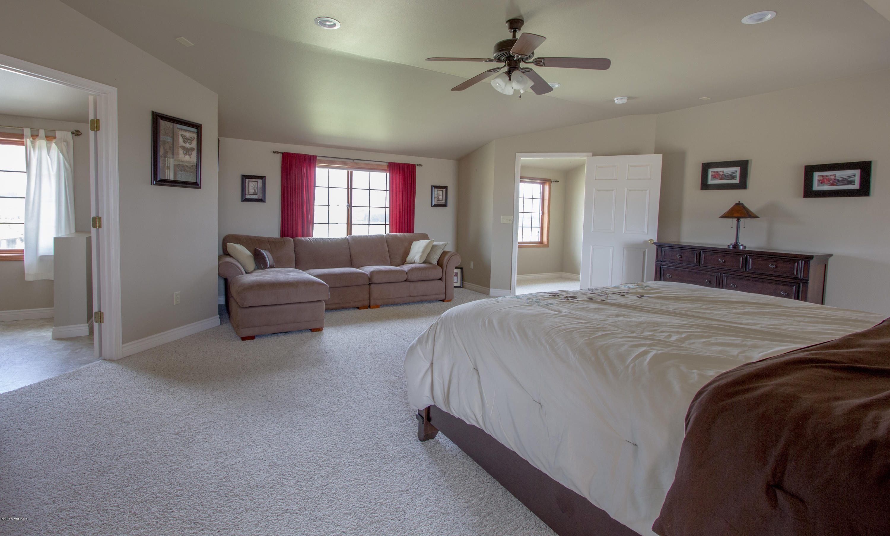 491 Section 1 Road Tieton, WA 98947 - Photo 16 of 23 a bedroom with a large bed couch and windows